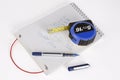 A note pad, pen and tape measure. Royalty Free Stock Photo
