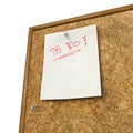 Note pad and push pin isolated on cork board Royalty Free Stock Photo