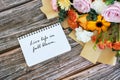 Note pad with text live life in full bloom with mixed flower bouquet Royalty Free Stock Photo