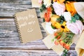 Note pad with text Worry less smile more with mixed flower bouquet