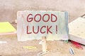 A note on paper with good luck wishes on the table secured with a clothespin Royalty Free Stock Photo