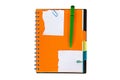 Note paper and orange notebook with green pen Royalty Free Stock Photo
