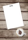 Note paper put on a old grunge wooden texture table with a cup hot coffee,top view, space for add your text or graphic editor