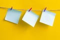 Note papers and decorative pin or clip isolated on yellow background. Office mock up. Top view, flat lay. Colorful office note or Royalty Free Stock Photo