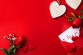 Note that says `I love you` inside an envelope with hearts and roses on red background Royalty Free Stock Photo