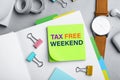 Note with text TAX FREE WEEKEND and stationery on table, flat lay Royalty Free Stock Photo