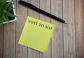 Note to self text on yellow stick note on wooden table Royalty Free Stock Photo