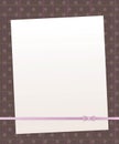 Note white paper on a dark brown background with vertical and horizontal stripes and round circles pink mother-of-pearl line bow r Royalty Free Stock Photo