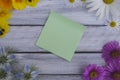 A note on a wooden surface framed by summer flowers 4 Royalty Free Stock Photo