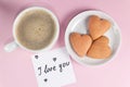 Note with the words I love you with cookies shaped heart and cup of coffee on pastel yellow color. Good morning or Valentine`s Da Royalty Free Stock Photo