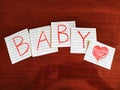 A note writing, caption, inscription baby reminder or advice on a note in wooden table