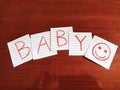 A note writing, caption, inscription Baby reminder or advice on a note in wooden table