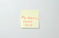 Note on yellow sticker paper sheets with motivation words my dreams come true. Royalty Free Stock Photo