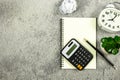 Notebook, alarm clock, calculator, white paper ball and pencil on the desk. Royalty Free Stock Photo