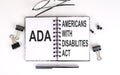 Notebook with Americans with Disabilities Act ADA on a table Royalty Free Stock Photo