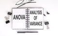 Notebook with ANOVA ANALYSIS OF VARIANCE on a table