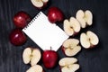 Notebook and apple on a black wooden background top view Royalty Free Stock Photo