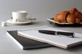 Notebook, ballpoint pen, coffee Cup and croissants Royalty Free Stock Photo