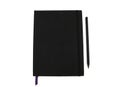 Black notebook, blank graph paper with square lines.it`s open both side of two pages in the white and isolated background Royalty Free Stock Photo