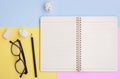 Notebook, Black pencil,Eyeglasses and eraser on pink,yellow and blue background Royalty Free Stock Photo