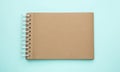 Notebook with brown paper pages on blue background, top view Royalty Free Stock Photo