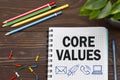 Notebook with a Business notes CORE VALUES on the office table with tools. Concept CORE VALUES with elements of infographics