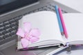 Notebook for business, pink and blue pencils and laptop computer keys Royalty Free Stock Photo