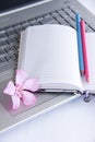 Notebook for business, pink and blue pencils and laptop computer keys Royalty Free Stock Photo