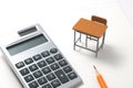 Notebook, calculator, pencil and miniature desk Royalty Free Stock Photo