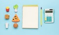 A notebook, a calculator and a set of fast food on a blue background Royalty Free Stock Photo