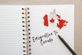 Notebook with canadian flag and country map with inscription emigration to Canada, emigration Royalty Free Stock Photo