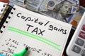 Notebook with capital gains tax sign on a table. Royalty Free Stock Photo