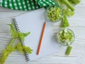 Notebook celery on wooden backgroundn vitamin food