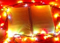 Notebook with Christmas garland on the table.