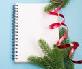 Notebook and Christmas tree branches. Christmas planning concept. Place for text. Christmas and New Year`s composition. Royalty Free Stock Photo