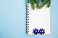 Notebook and Christmas tree branches. Christmas planning concept. Place for text. Christmas and New Year`s composition. Royalty Free Stock Photo