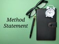Notebook,clock and glasses with the word Method Statement Royalty Free Stock Photo