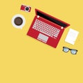 Notebook coffee and laptop on yellow top view background