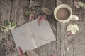 Notebook and coffee on wooden table decorated with dried leaves Royalty Free Stock Photo