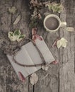Notebook and coffee on wooden table decorated with dried leaves Royalty Free Stock Photo