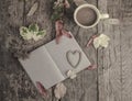 Notebook and coffee on wooden table decorated with dried leaves Royalty Free Stock Photo