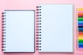 Notebook and colored pencils on pink background Royalty Free Stock Photo