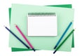 Notebook and colored pencils on sheets of textured paper Royalty Free Stock Photo