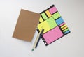 Notebook, colorful stickers, pencil and pen on a white background