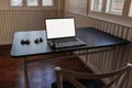 A notebook computer and a combination lock are placed on a black table. A hacker`s notebook computer that prepares to compromise