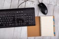 Notebook computer keyboard and mouse on a white table. Office accessories for work Royalty Free Stock Photo