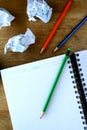 Notebook, crumpled papers and colorful pencils Royalty Free Stock Photo