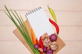 Notebook for culinary recipes with fresh organic vegetables