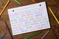 Notebook with different baby names and colorful markers on wooden table, flat lay Royalty Free Stock Photo