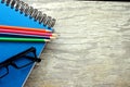 Notebook, eyeglasses and colorful pencils